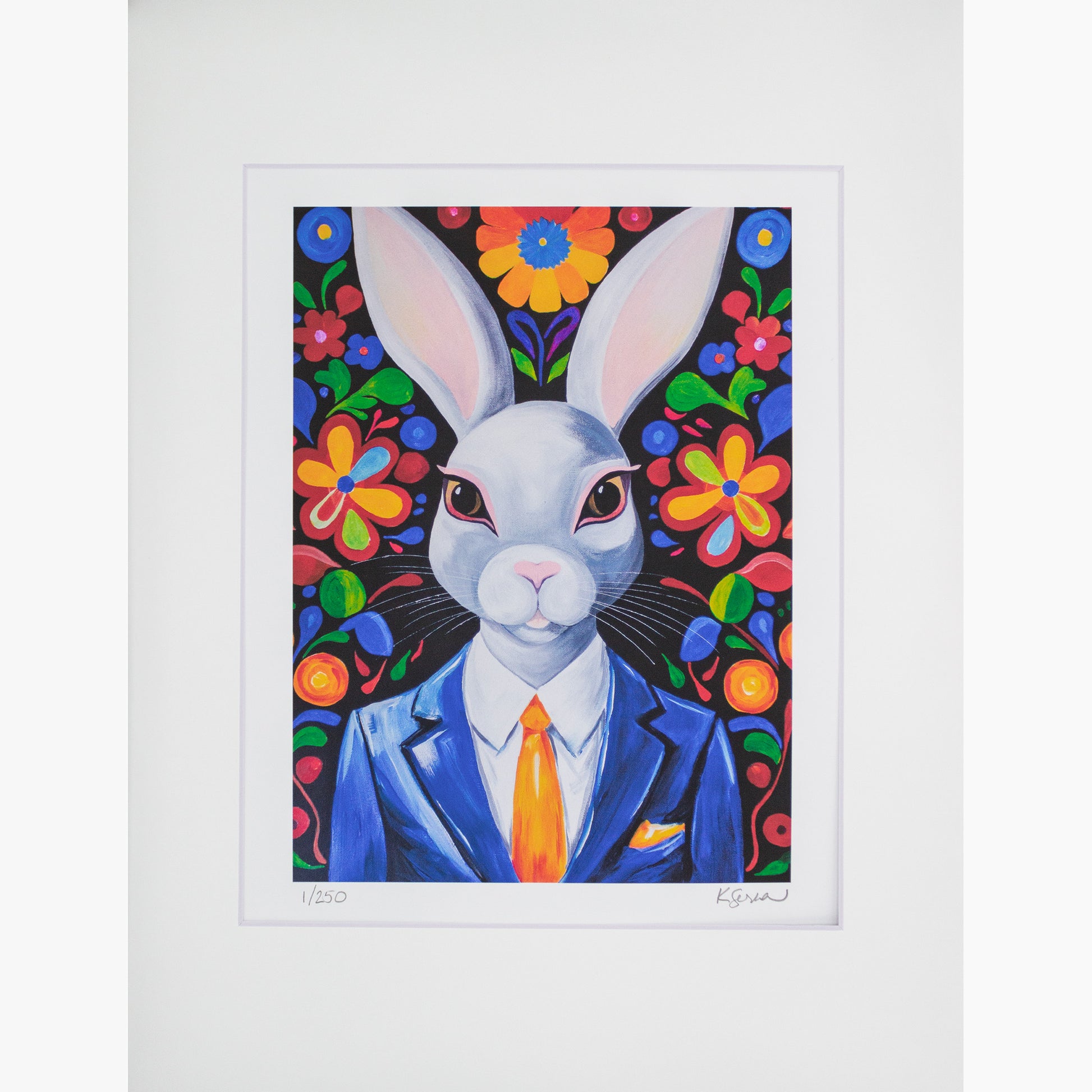 A close-up of a limited edition print featuring Archie the Rabbit, a confident white rabbit dressed in a sharp blue suit, white shirt, and orange tie. The background is a bold floral pattern with large, colorful flowers set against black. The print is matted with a white border, and the artist’s signature and edition number (1/250) are visible at the bottom.