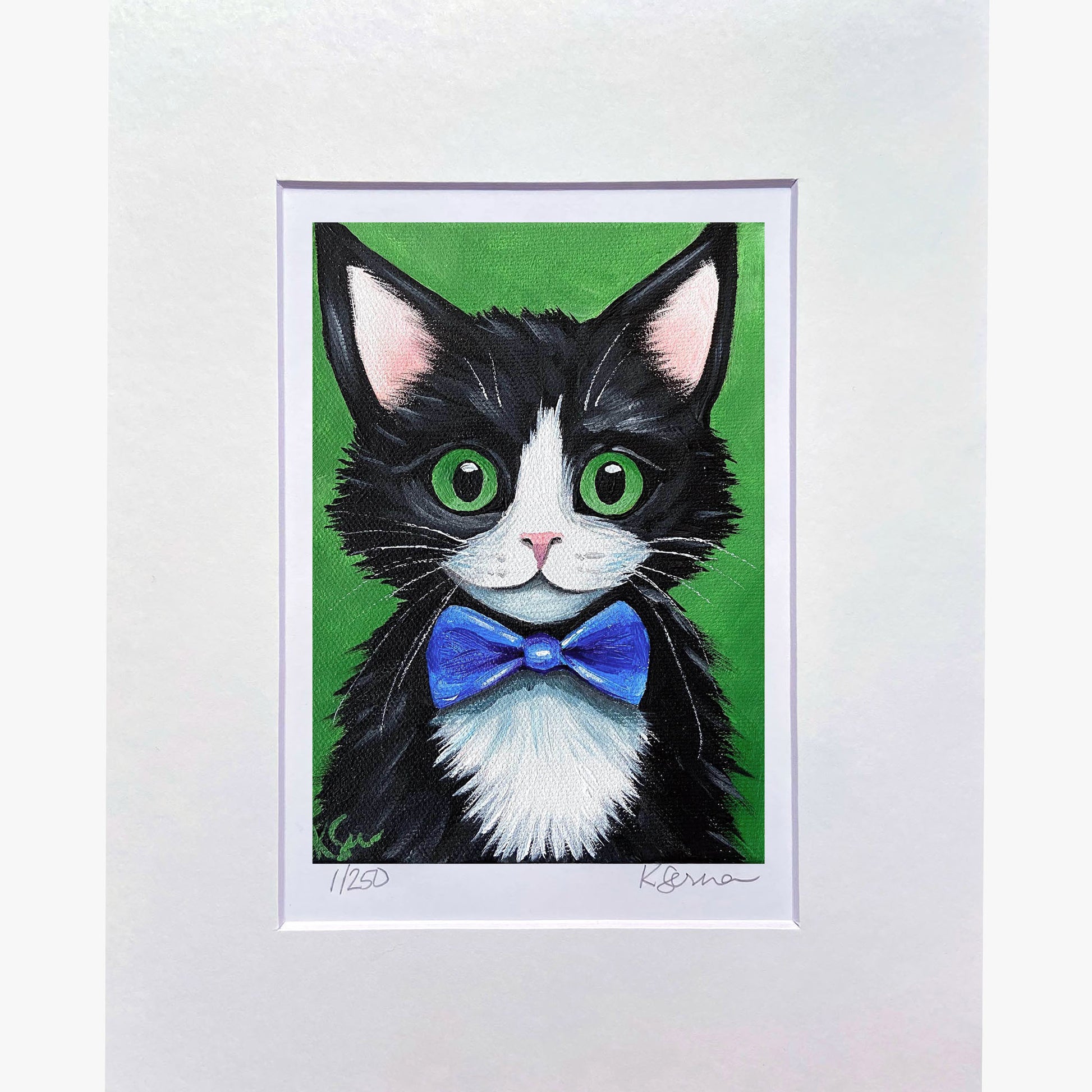 Framed artwork of a black and white cat with a blue bow tie on a green background