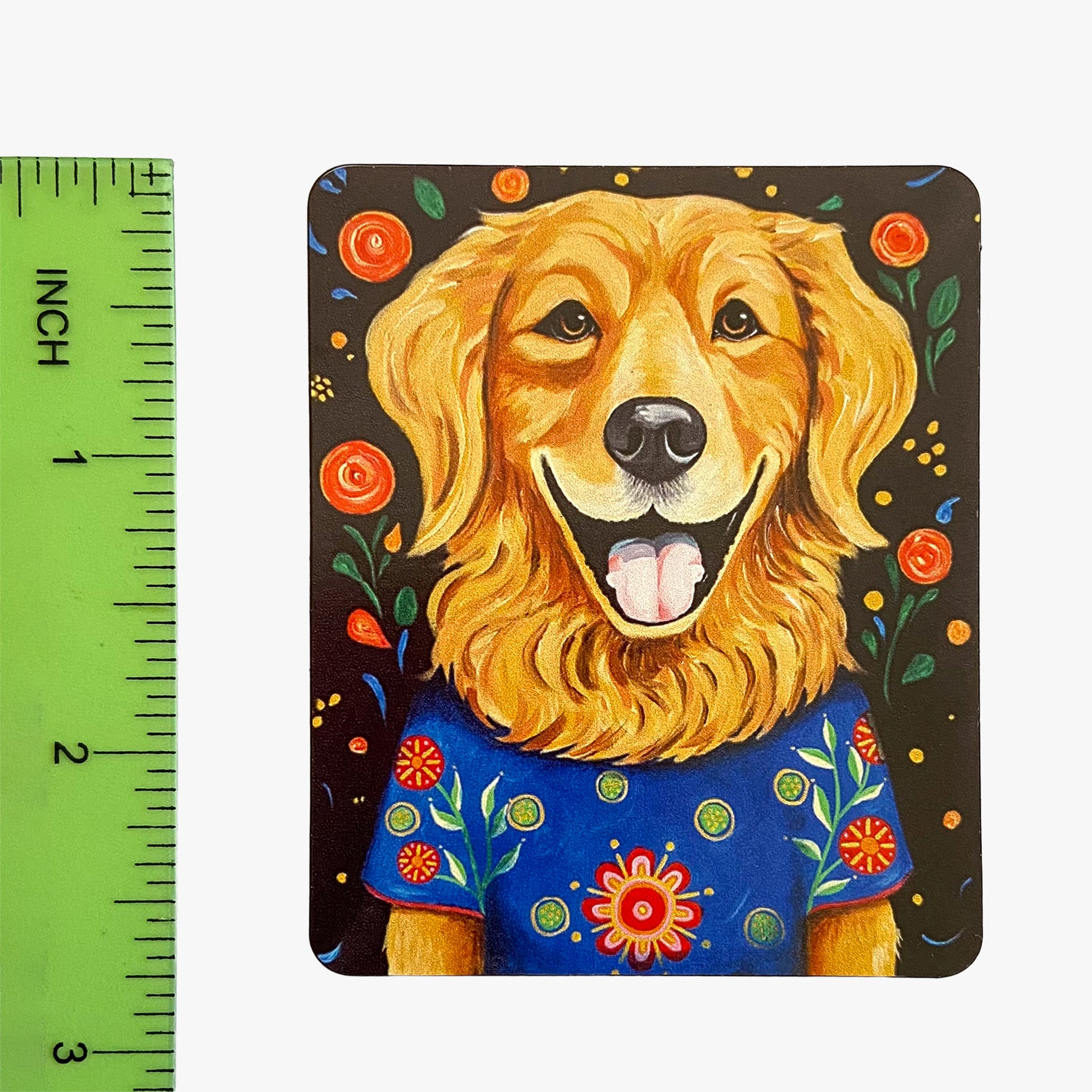 Magnet with a colorful illustration of a dog wearing a blue shirt, next to a ruler for scale.