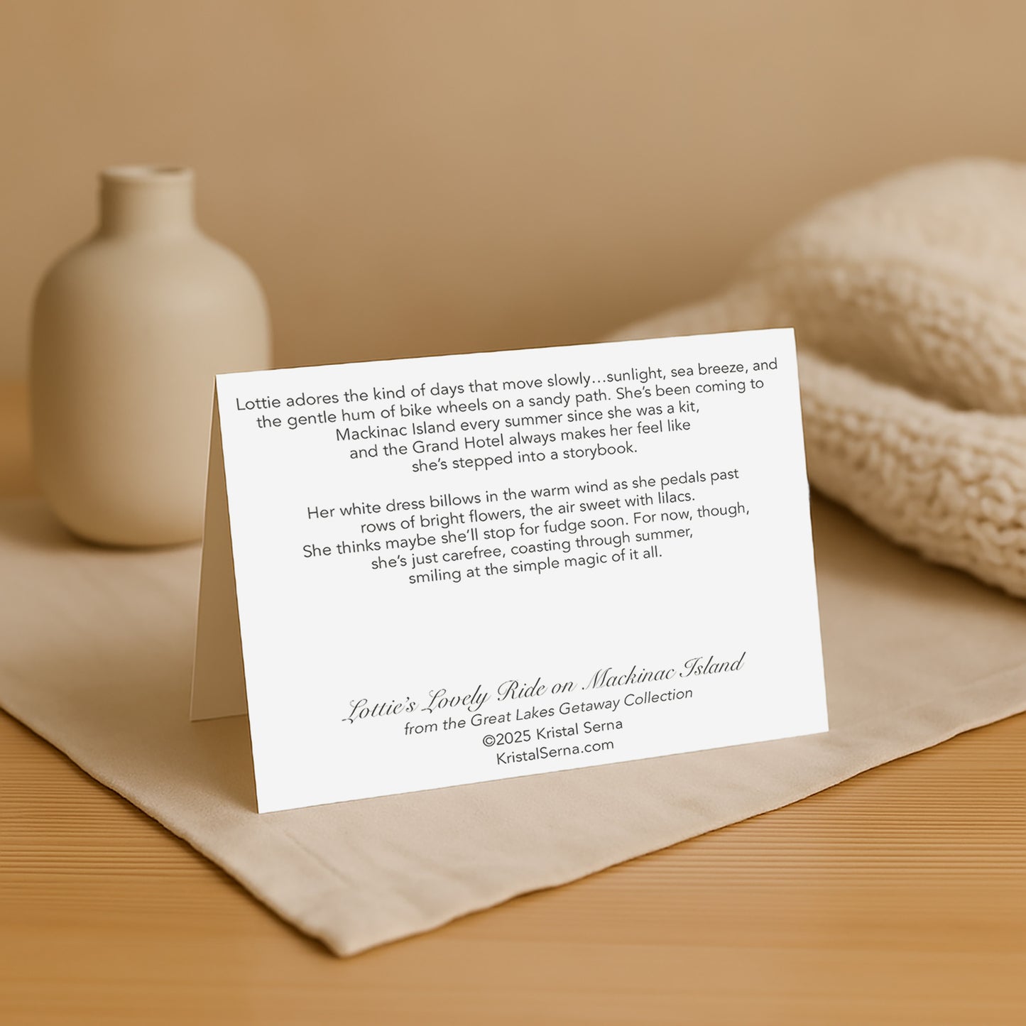 Greeting card with text on a beige surface with a vase and knitted item in the background
