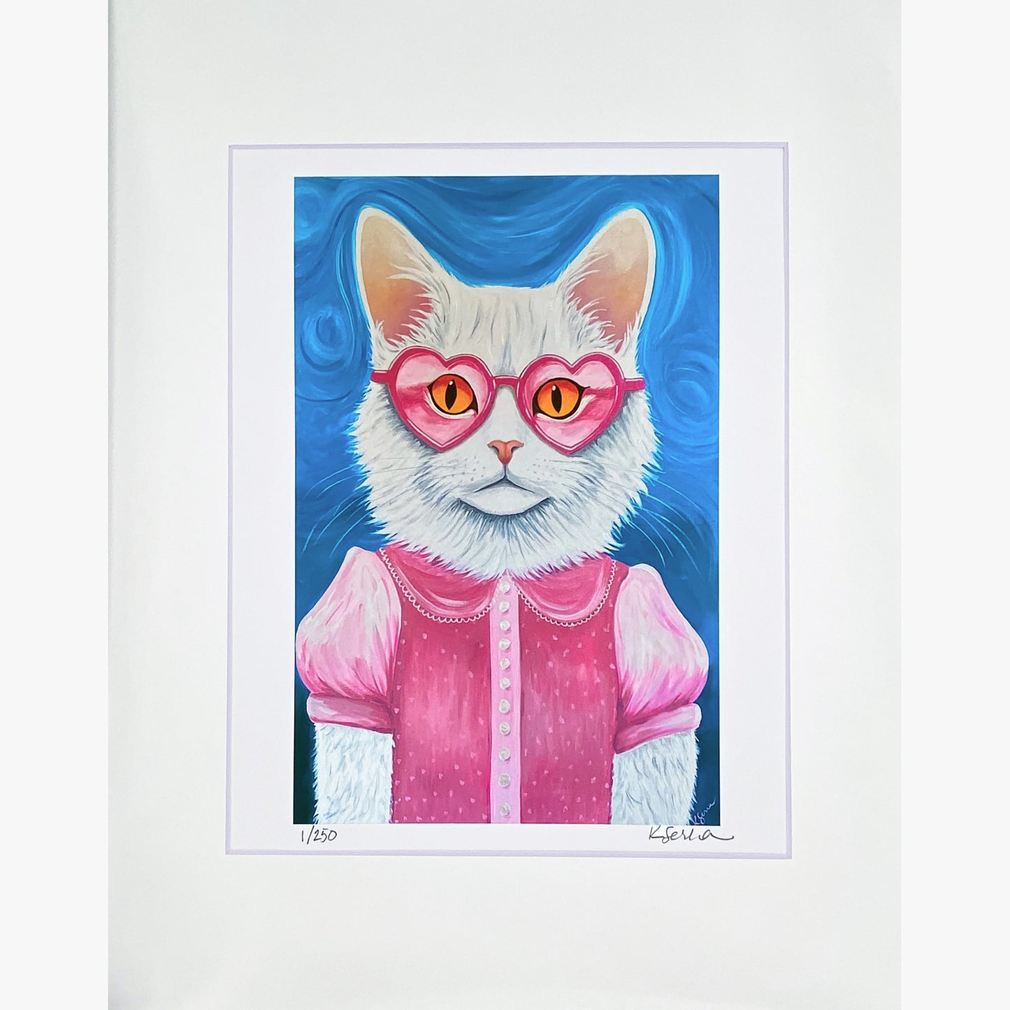 A close-up of a limited edition print featuring Lulu the Cat, a stylish white feline with striking golden eyes. She wears heart-shaped pink glasses and a vintage-inspired pink dress with puffed sleeves, delicate pearl details, and tiny buttons down the front. The background is a soft swirling blue. The print is matted with a white border, and the artist’s signature and edition number (1/250) are visible at the bottom.