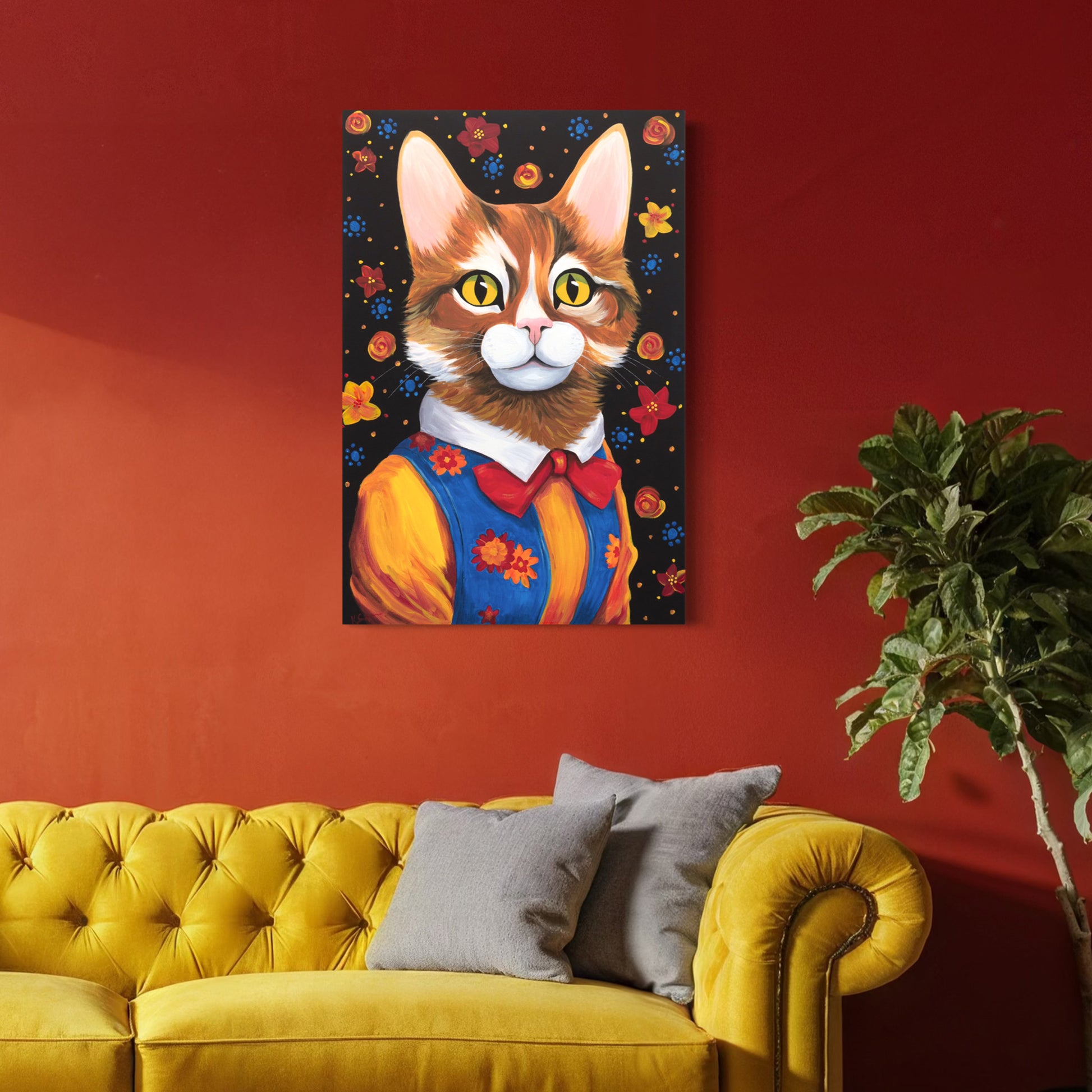 The playful portrait of Maisie, the tabby cat, displayed against a deep red wall above a yellow tufted couch, adding warmth and charm to the space.