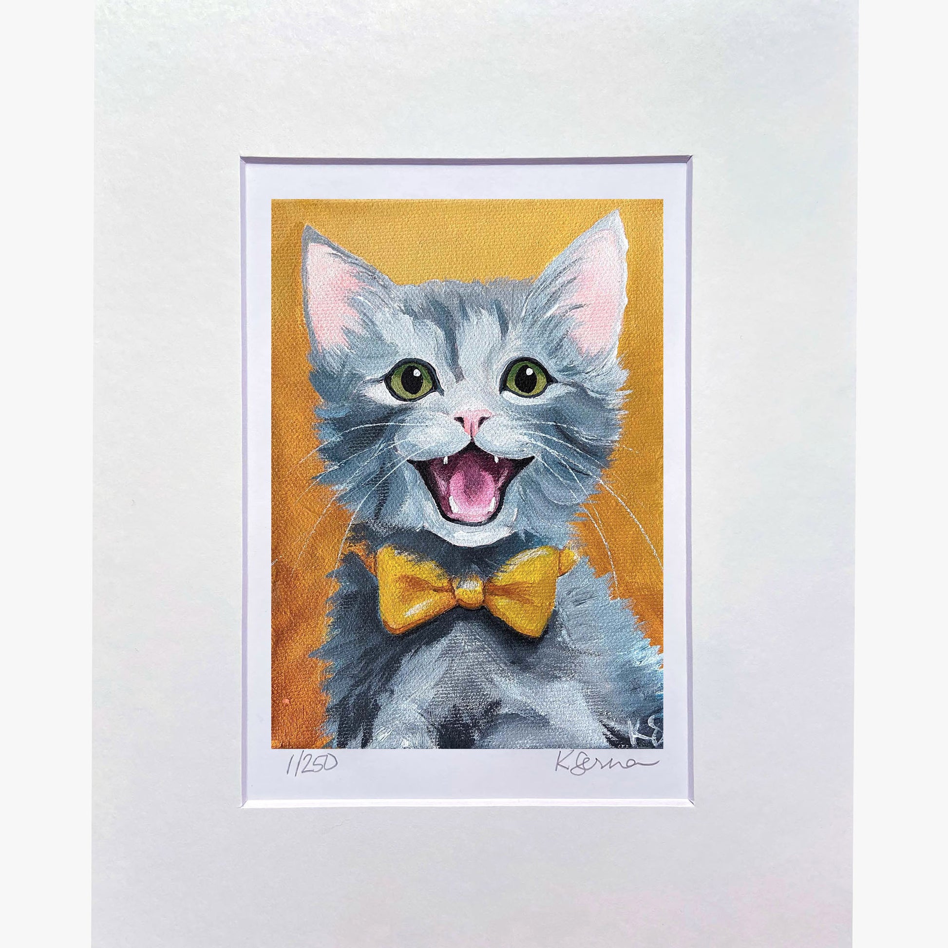 Framed artwork of a gray kitten with a yellow bow tie on an orange background