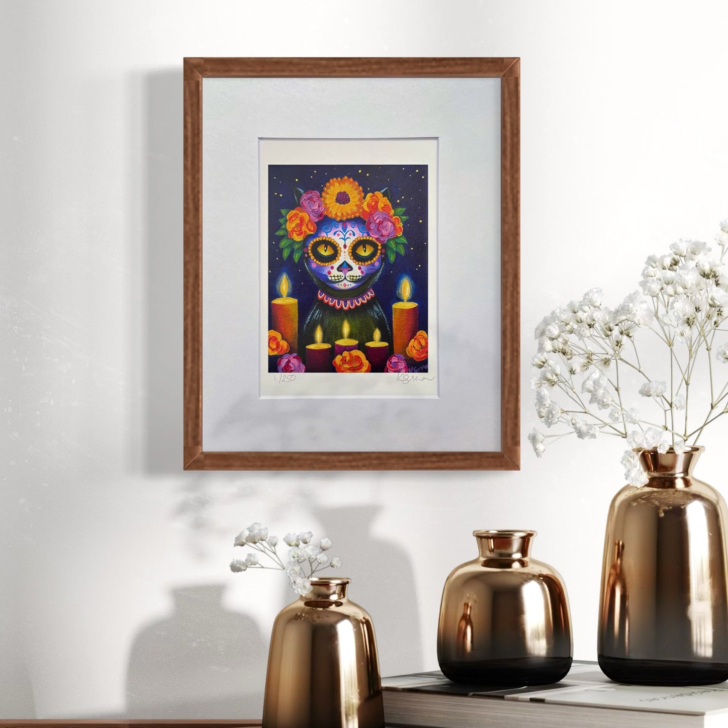 Framed artwork of a colorful skull with flowers and candles on a wall above decorative vases.