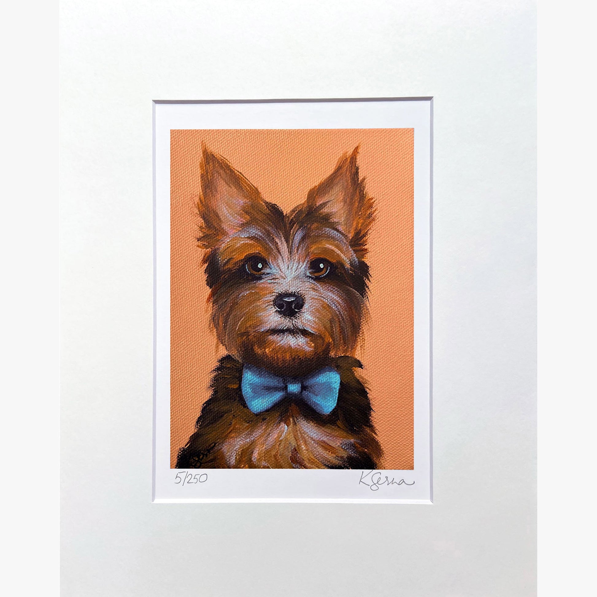 Framed artwork of a dog with a blue bow tie on an orange background