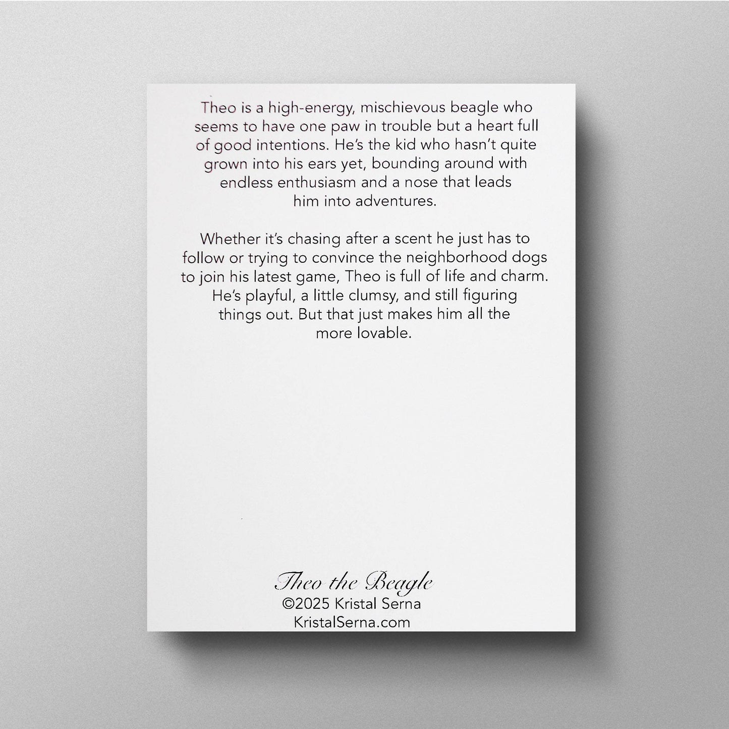 A printed card featuring a description of Theo the Beagle’s personality. The text highlights his high energy, mischievous nature, and playful charm. It describes him as a pup who hasn’t quite grown into his ears yet, always on an adventure and figuring things out. The card includes the artist’s name, Kristal Serna, and her website at the bottom.