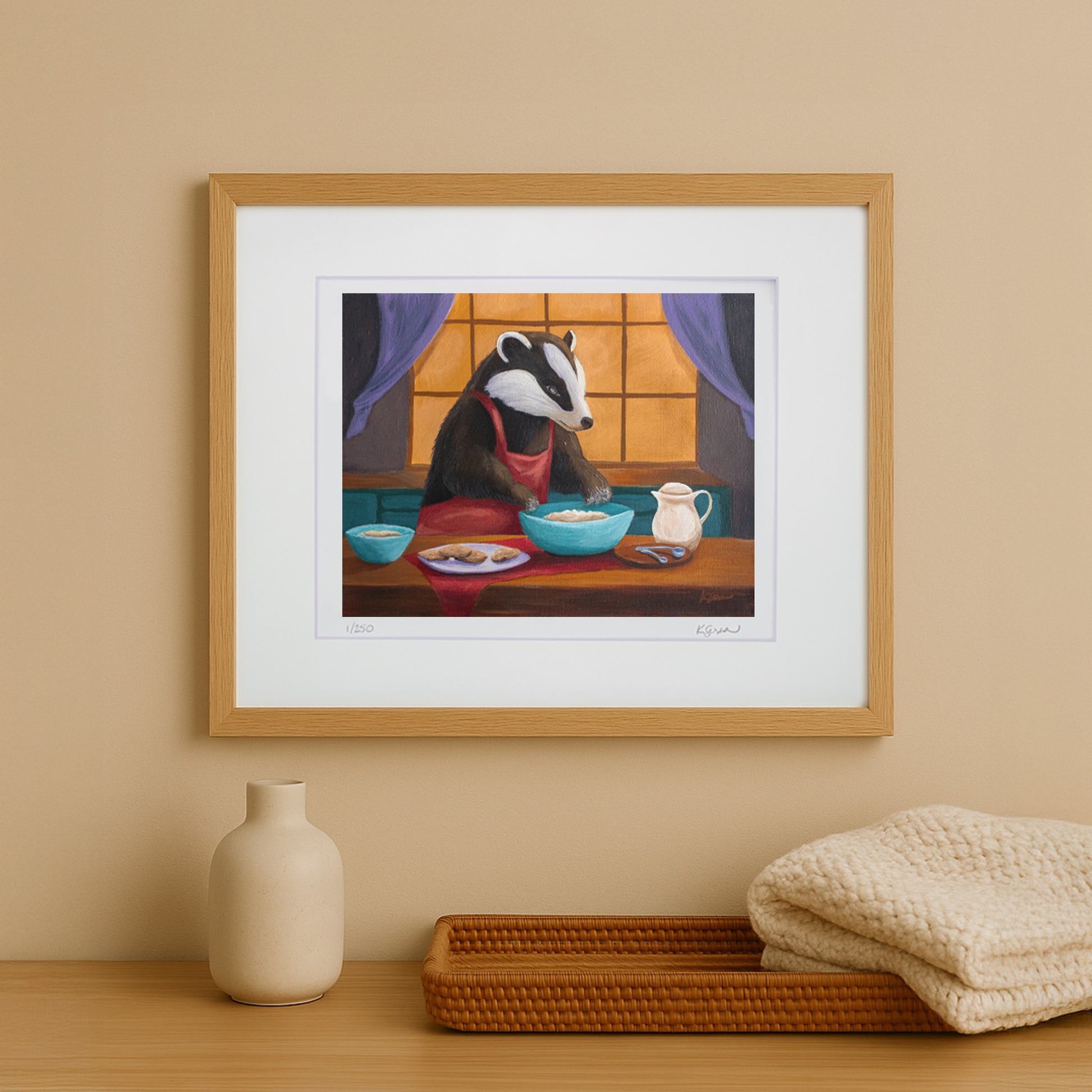 Framed artwork of a badger at a table with a vase and basket on a wooden surface.
