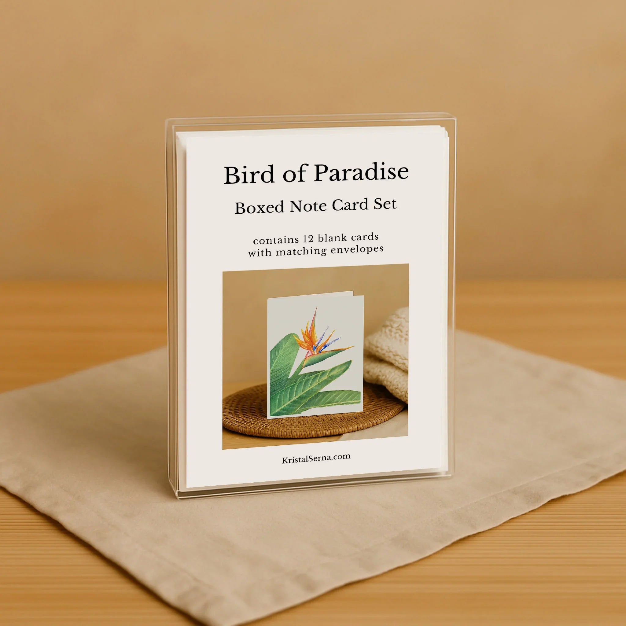 Boxed note card set with 'Bird of Paradise' design on a beige surface.