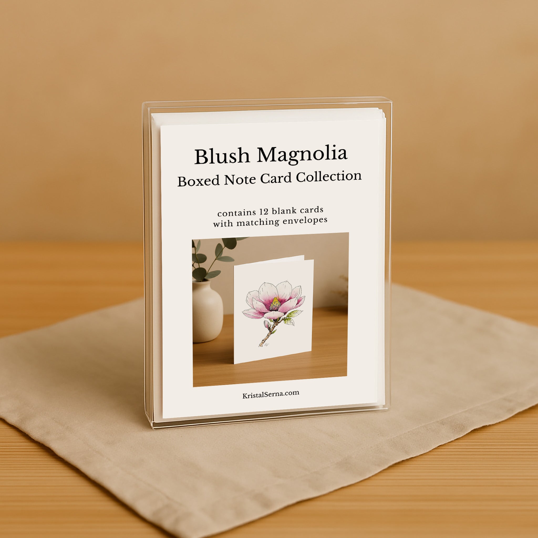 Blush Magnolia boxed note card collection on a wooden surface with a beige background