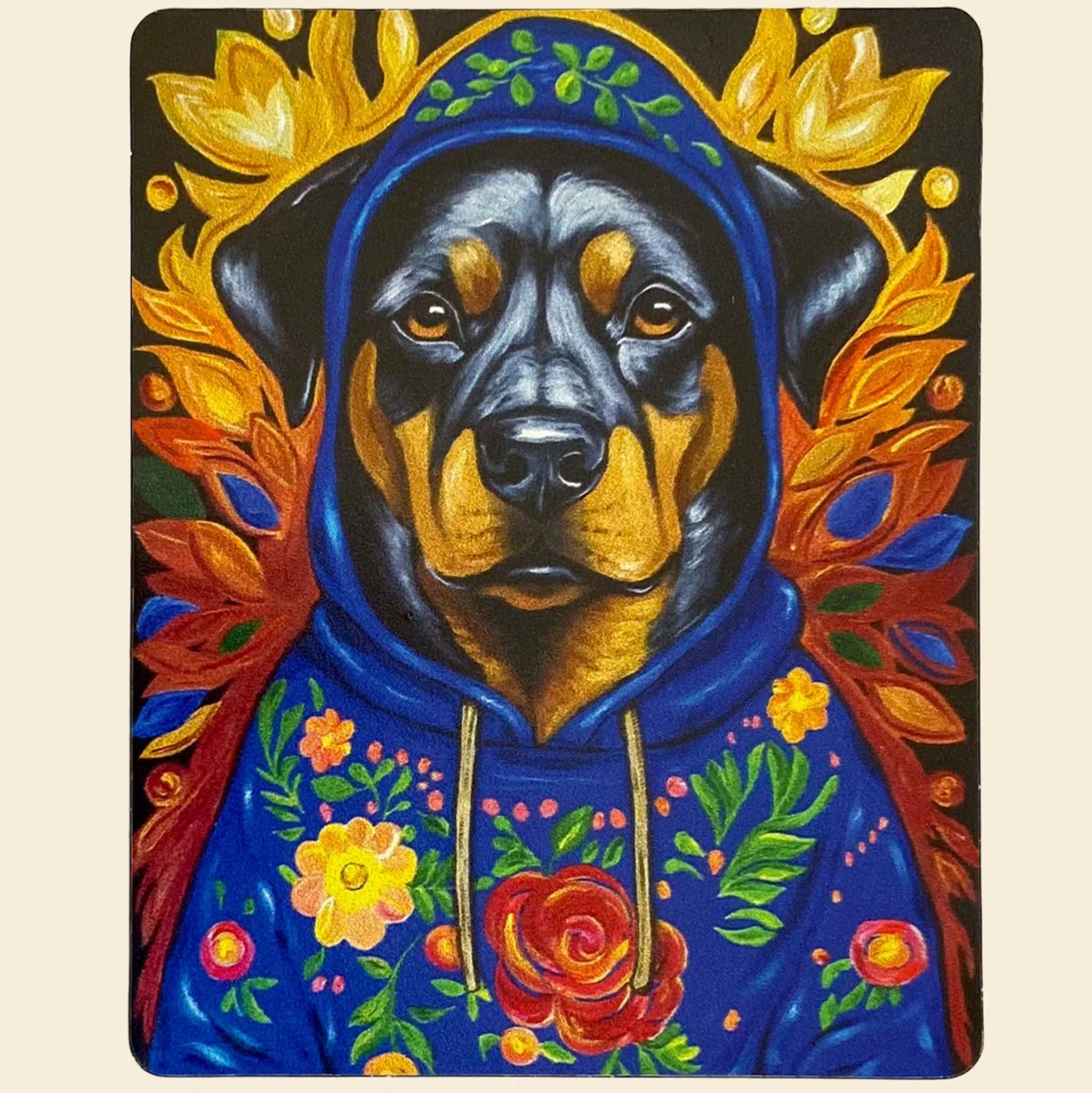 Dog wearing a blue hoodie with floral designs on a colorful background