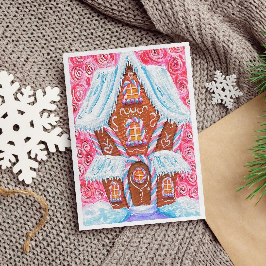 A colorful acrylic painting of a gingerbread house decorated with candy cane stripes, peppermint swirls, and snowy icing rooftops against a pink background.