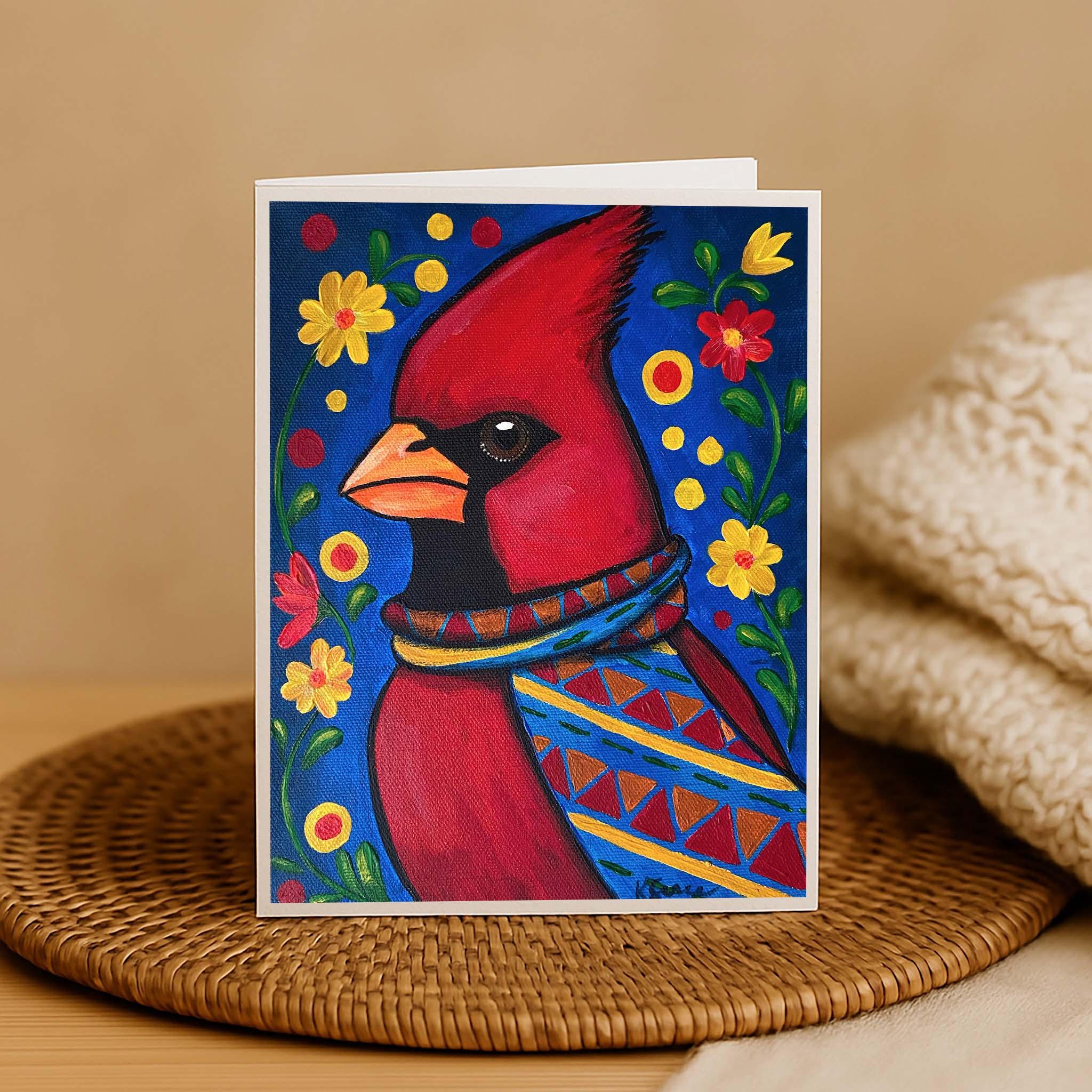 Card with a colorful illustration of a cardinal bird on a woven mat.