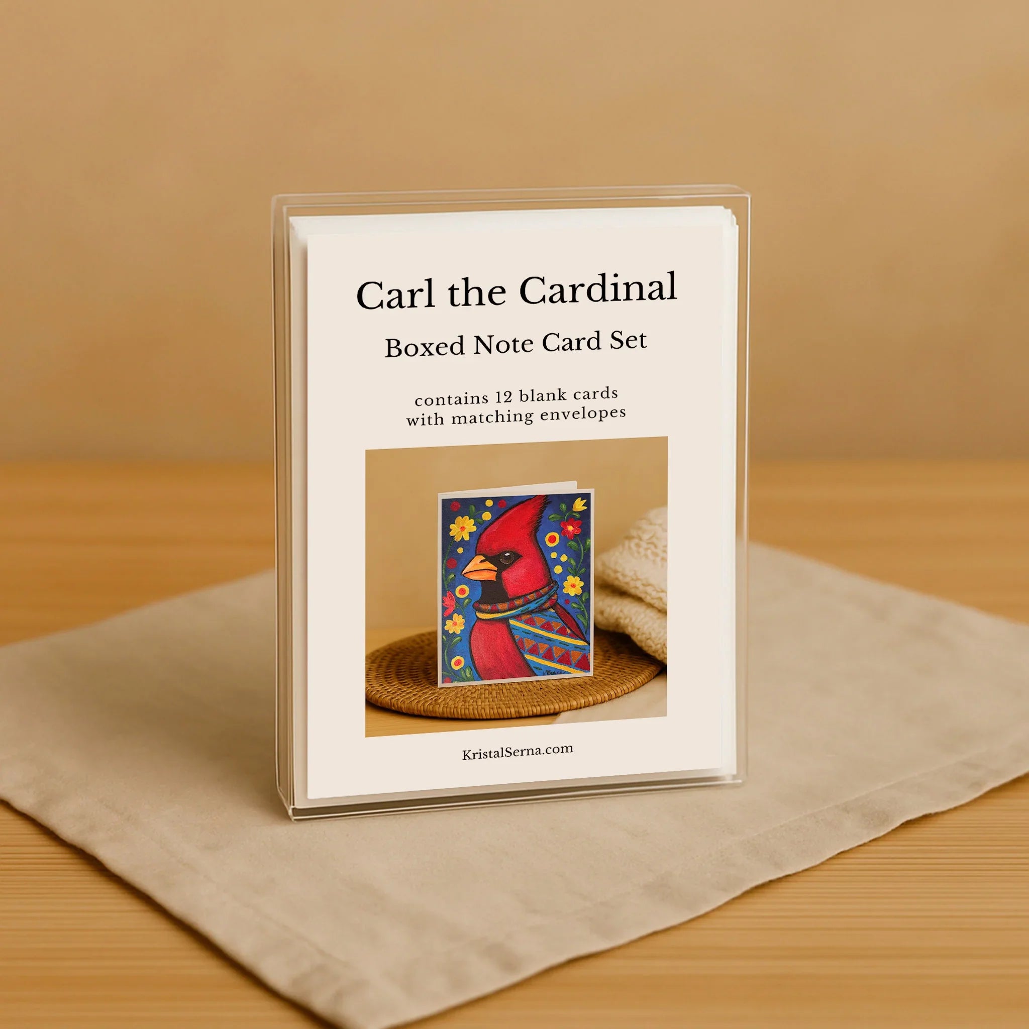 Boxed note card set for 'Carl the Cardinal' with a colorful cardinal illustration on a beige background.