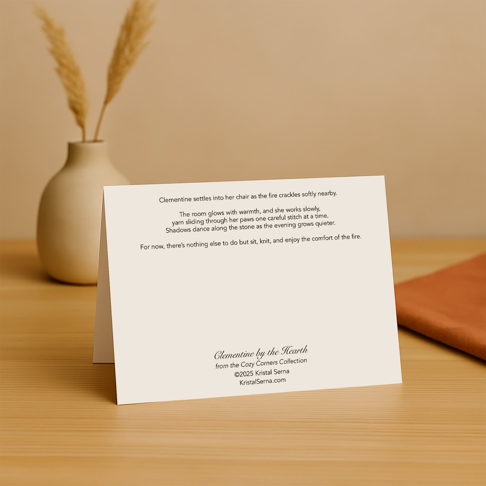 White card with text on a wooden surface with a vase and dried plants in the background