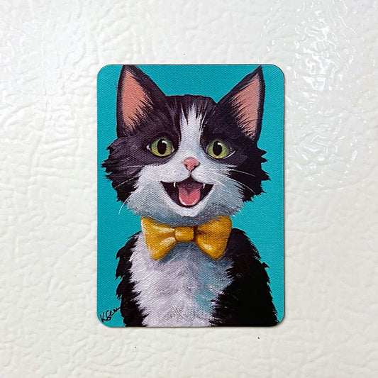 Fridge magnet with a cartoon cat wearing a yellow bow tie on a white background