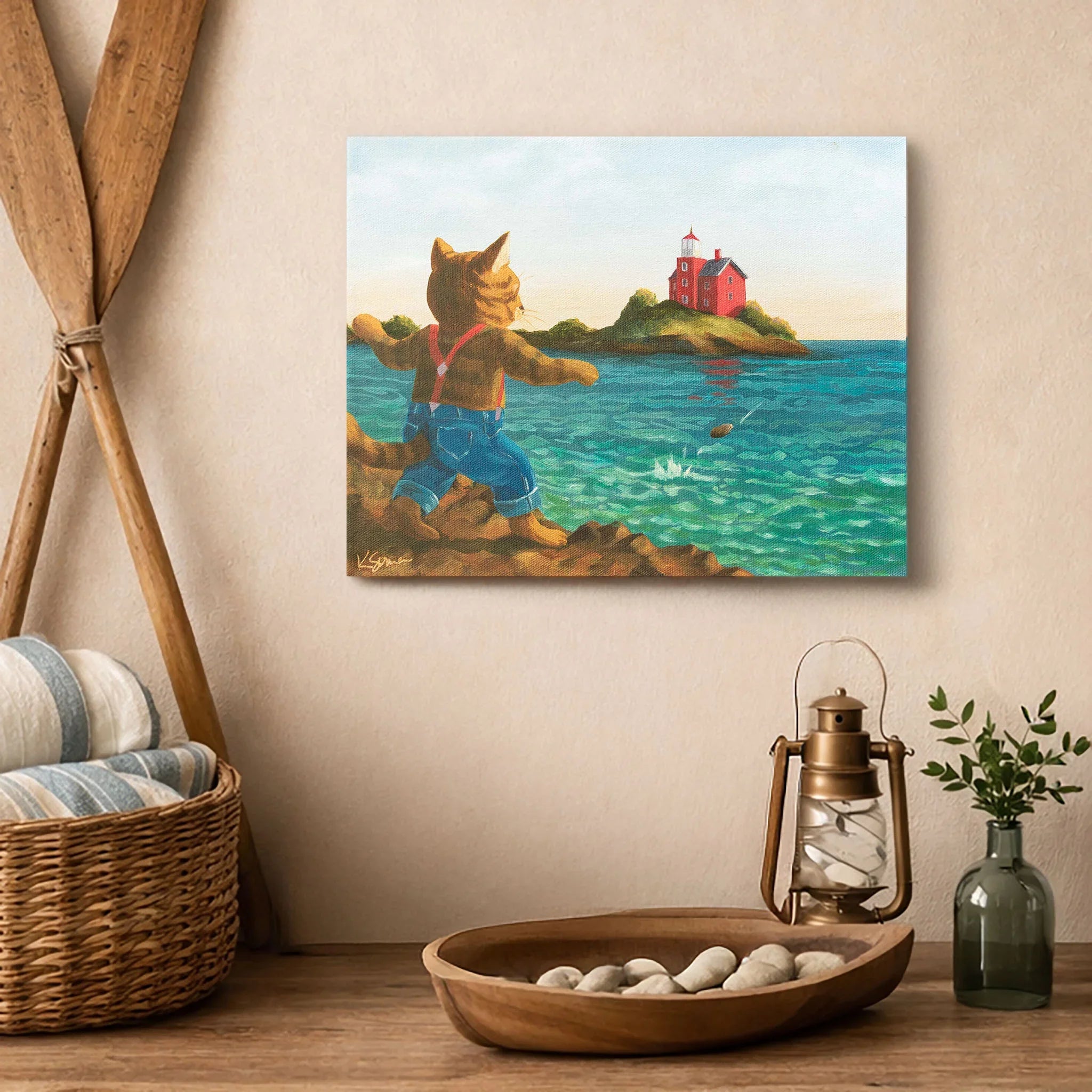 Painting of a cat at the Marquette Harbor with a lighthouse on a wall above a wooden shelf.