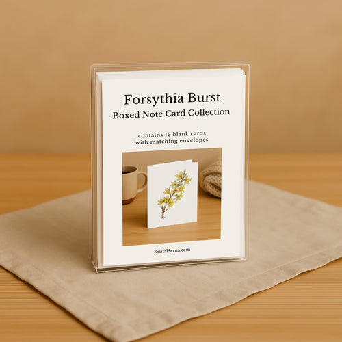 Forsythia Burst boxed note card collection on a wooden surface with a beige background