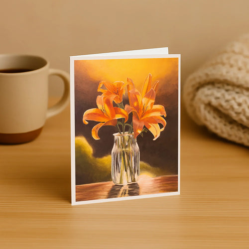 Greeting card with orange flowers in a vase on a wooden surface with a mug and knitted item in the background.
