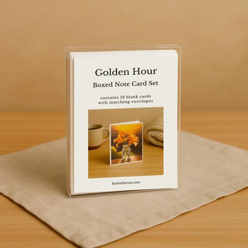 Boxed note card set titled 'Golden Hour' on a wooden surface with a beige background