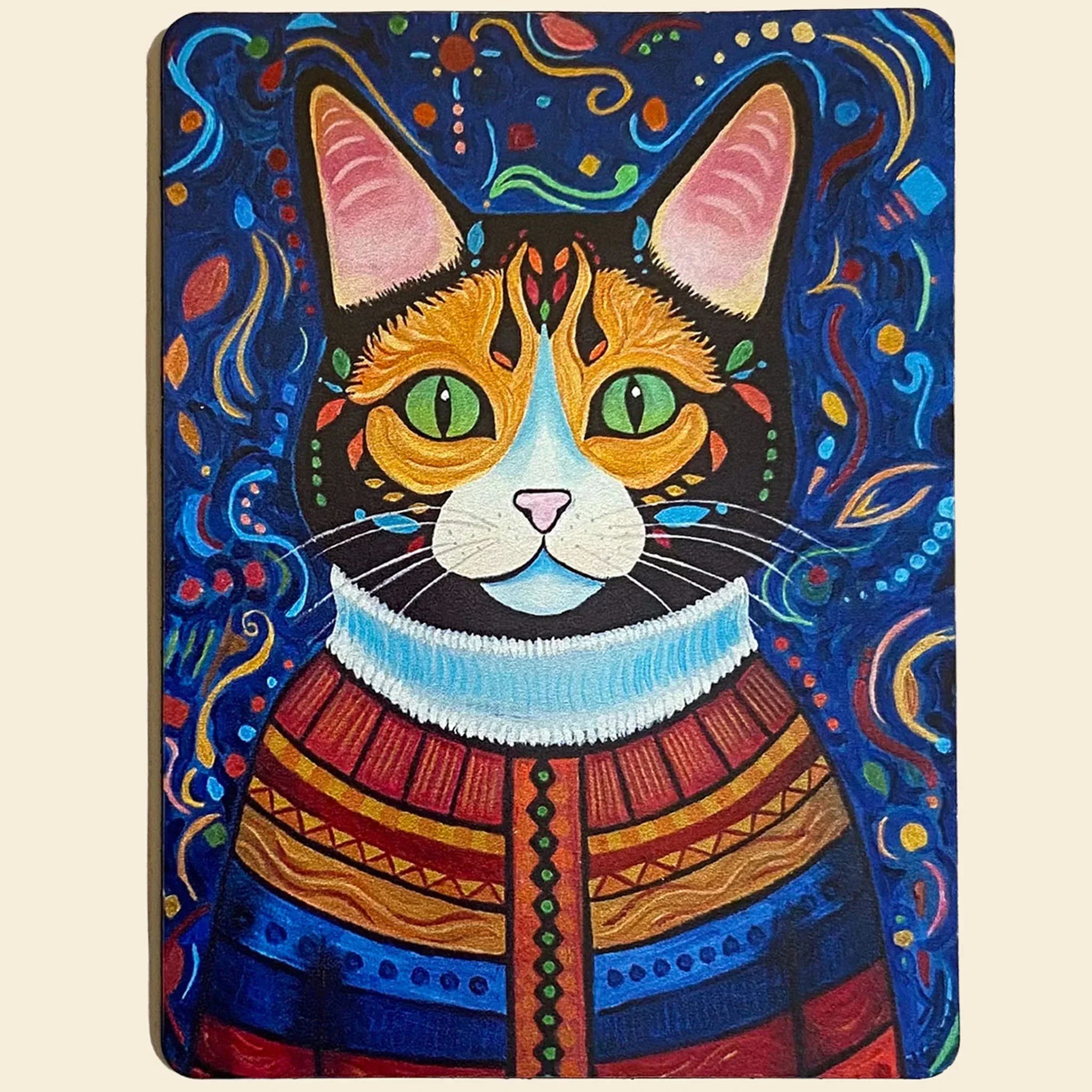Magnet of a cat wearing a sweater with abstract patterns