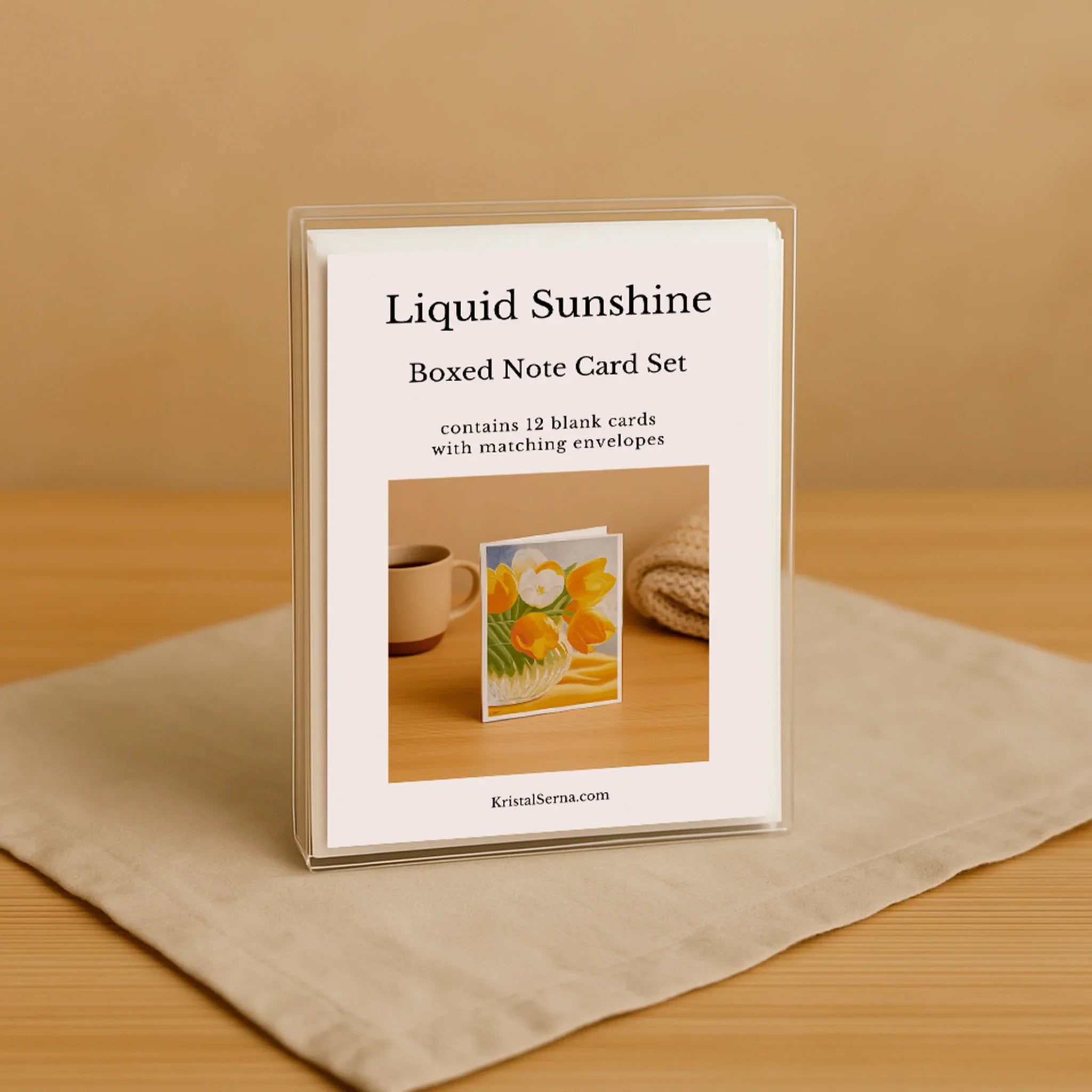Boxed note card set with 'Liquid Sunshine' branding on a wooden surface.