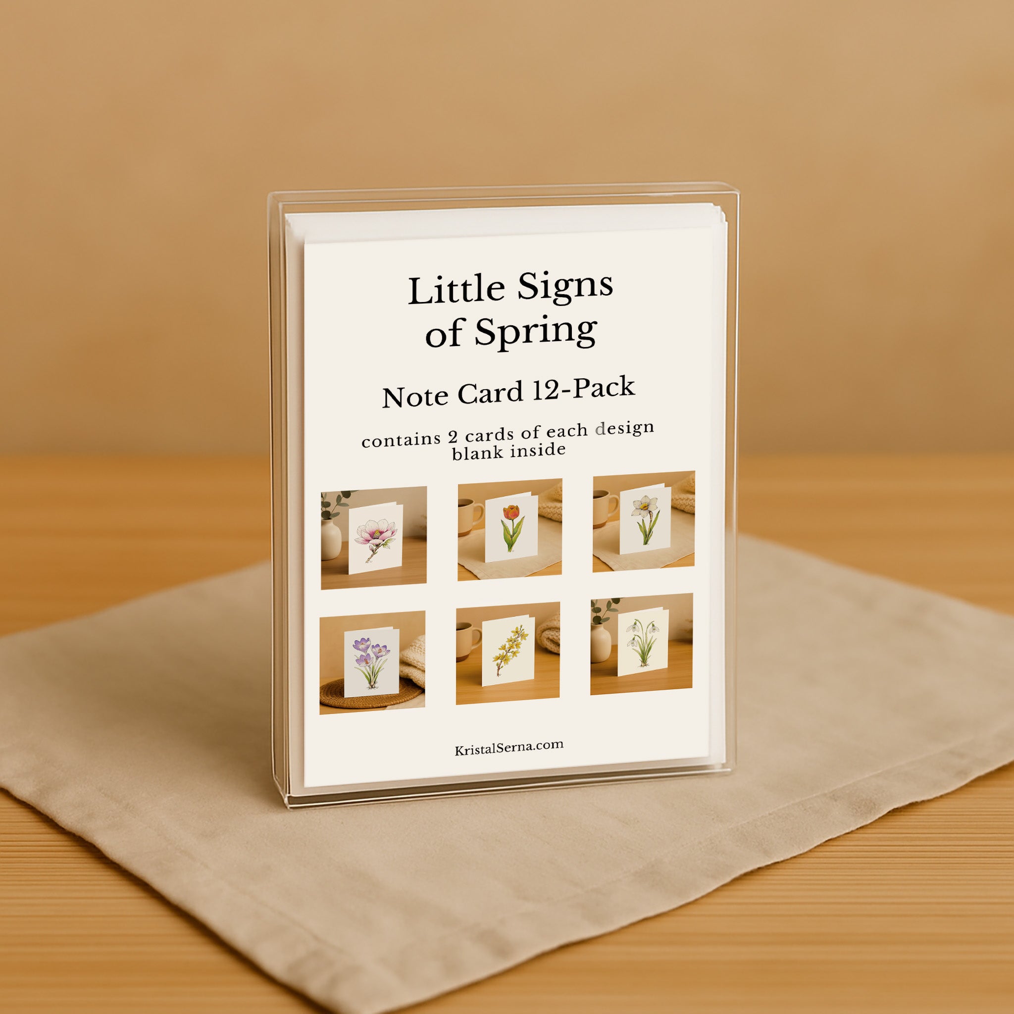 Packaging of 'Little Signs of Spring' note cards on a beige surface with a brown background