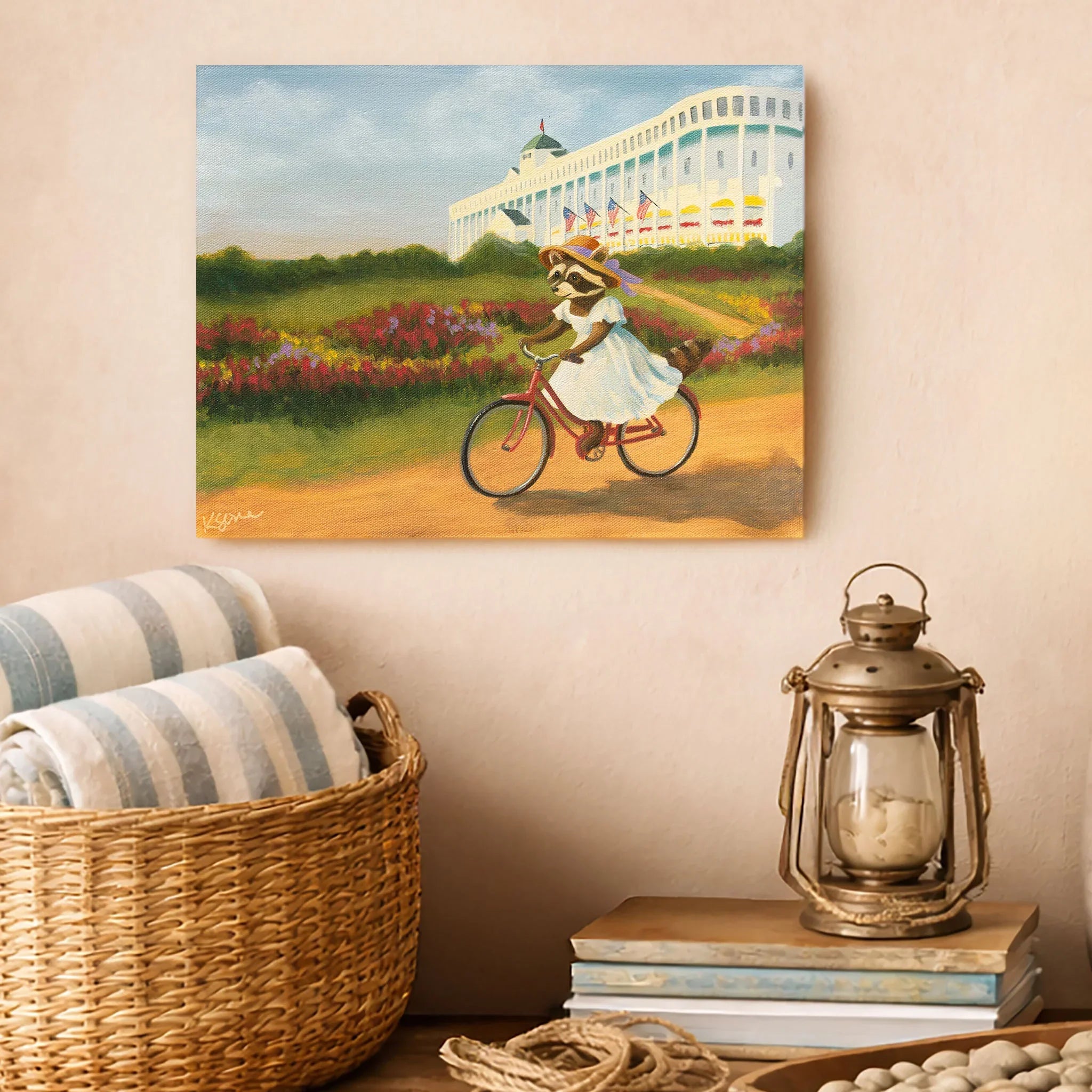 Painting of a raccoon riding a bike in a garden on a wall above a basket and lantern.