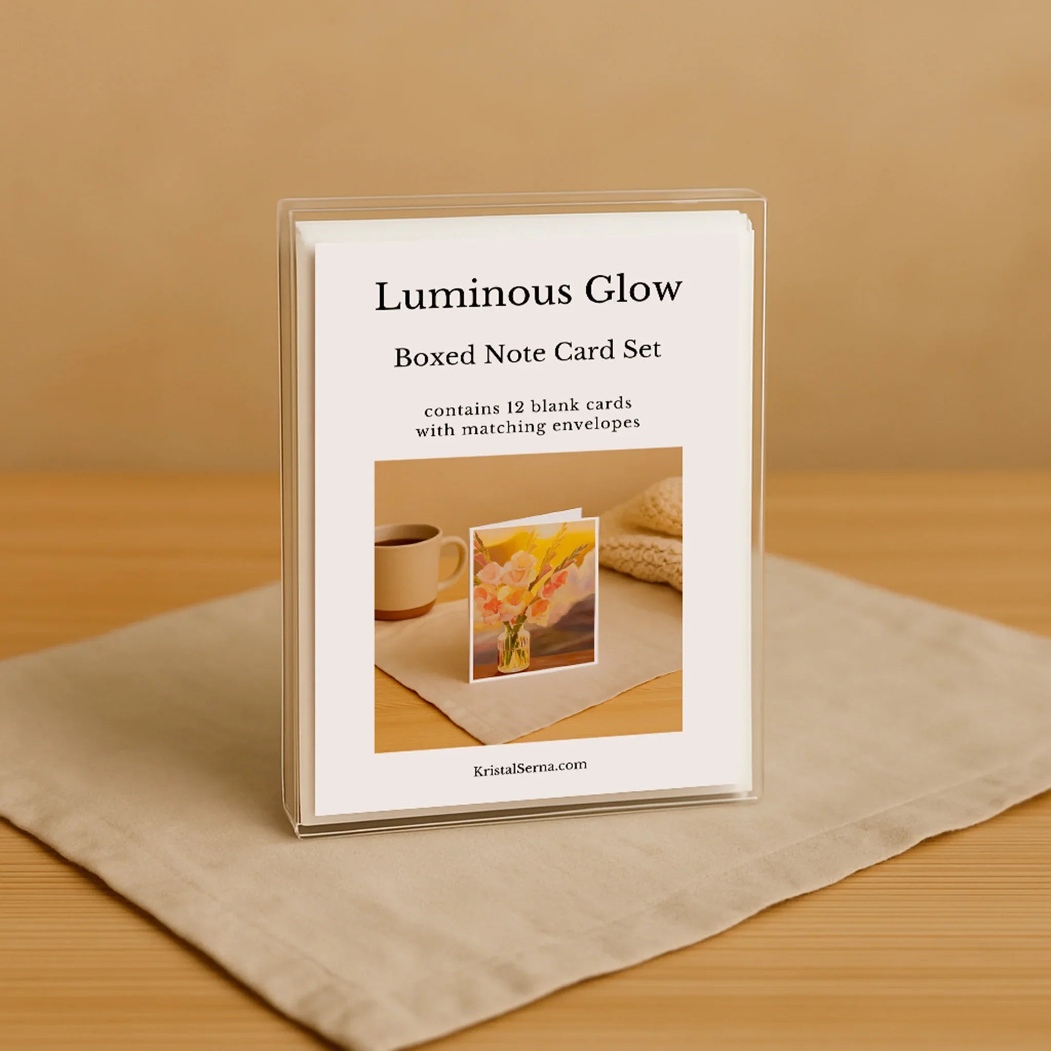 Luminous Glow Boxed Note Card Set packaging on a wooden surface with a beige background