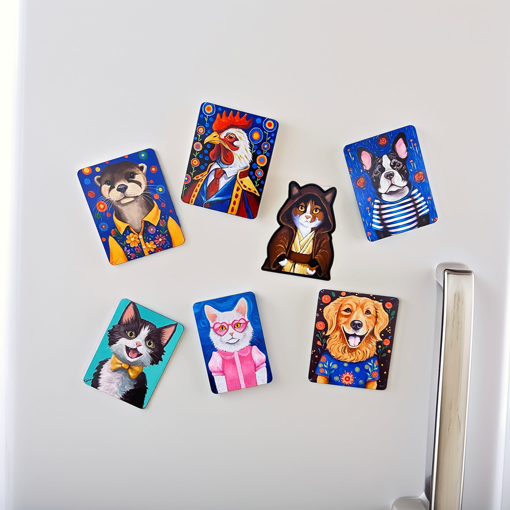 Set of colorful animal-themed magnets on a white refrigerator.