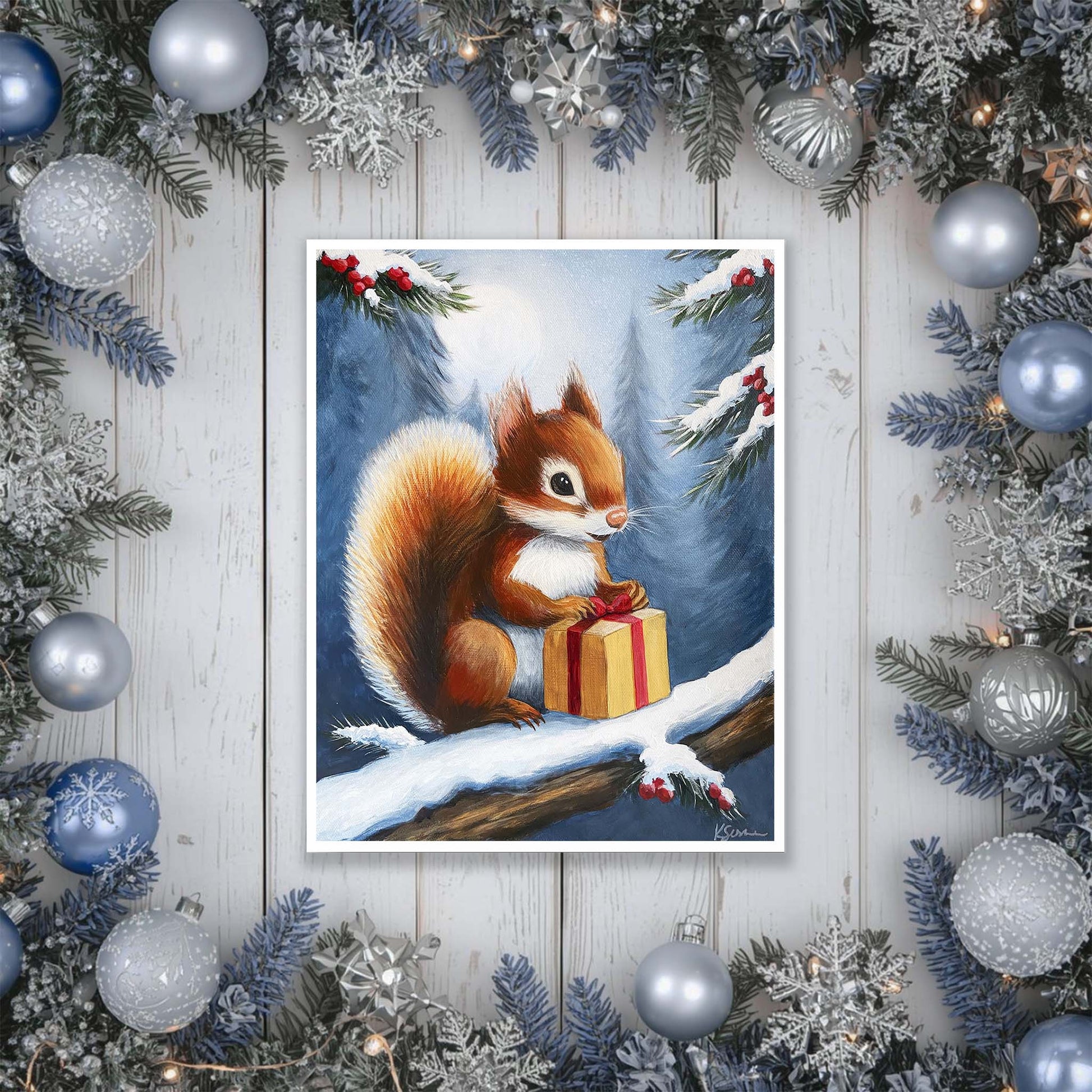 artwork of a squirrel with a gift surrounded by Christmas decorations on a wooden surface.
