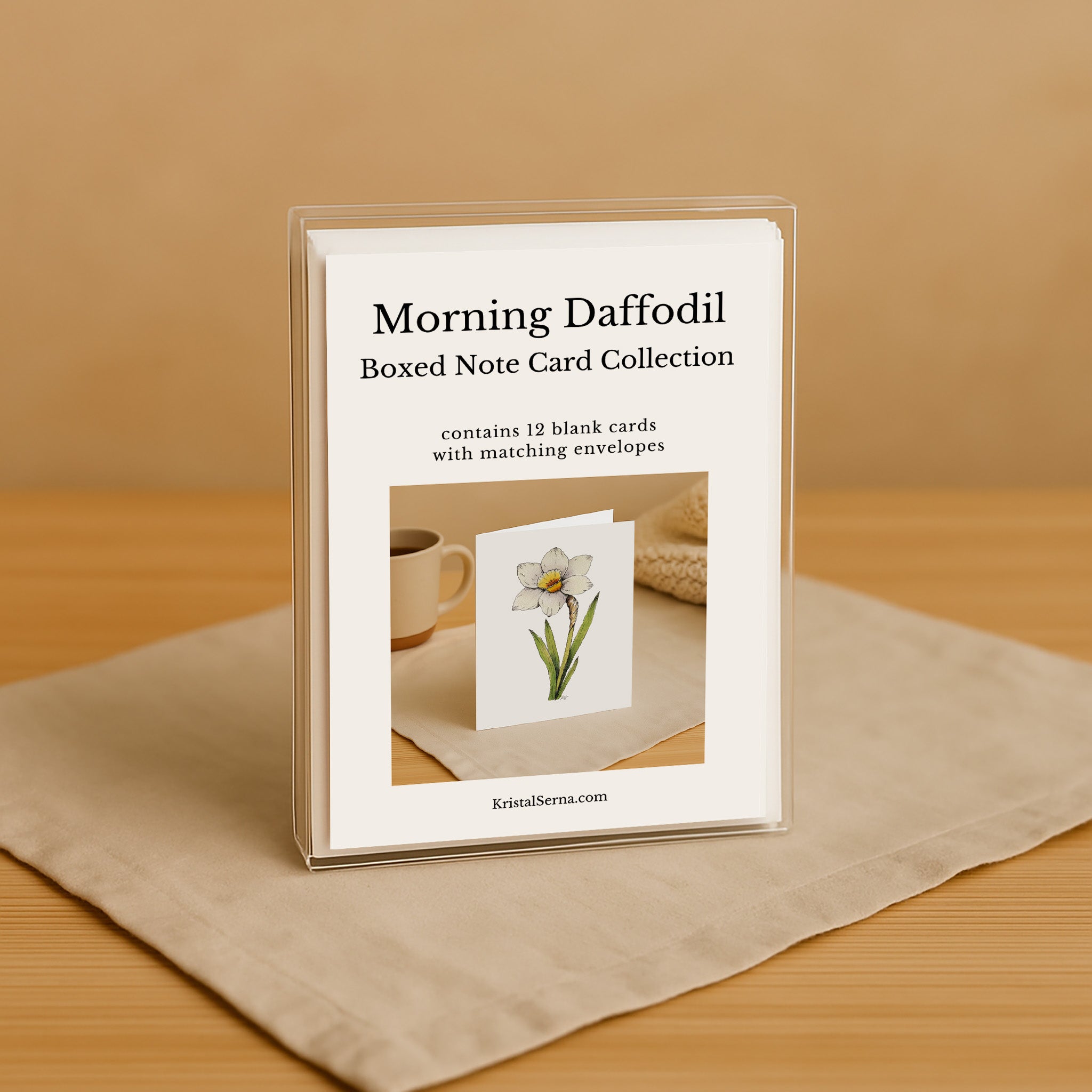 Boxed note card collection with a daffodil design on a beige surface.