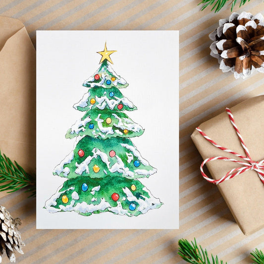 A watercolor and ink painting of a decorated Christmas tree covered in snow with colorful ornaments and a gold star on top.