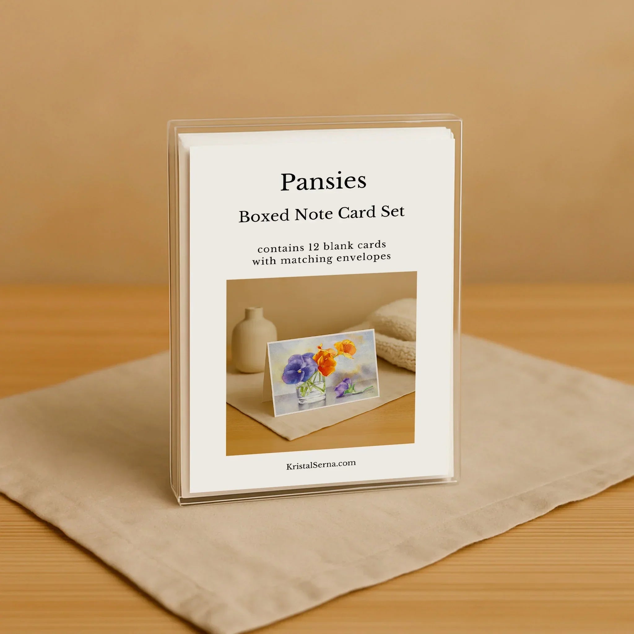 Boxed note card set with a floral card on a wooden surface