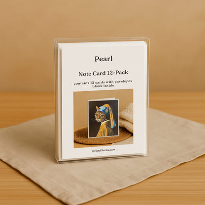 Note card set with cat illustration and 'Pearl' branding on a beige surface.