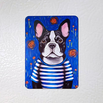 Fridge magnet with a dog illustration wearing a striped shirt on a white background