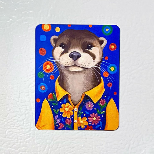 Magnet with a cartoon otter wearing a yellow shirt on a white background
