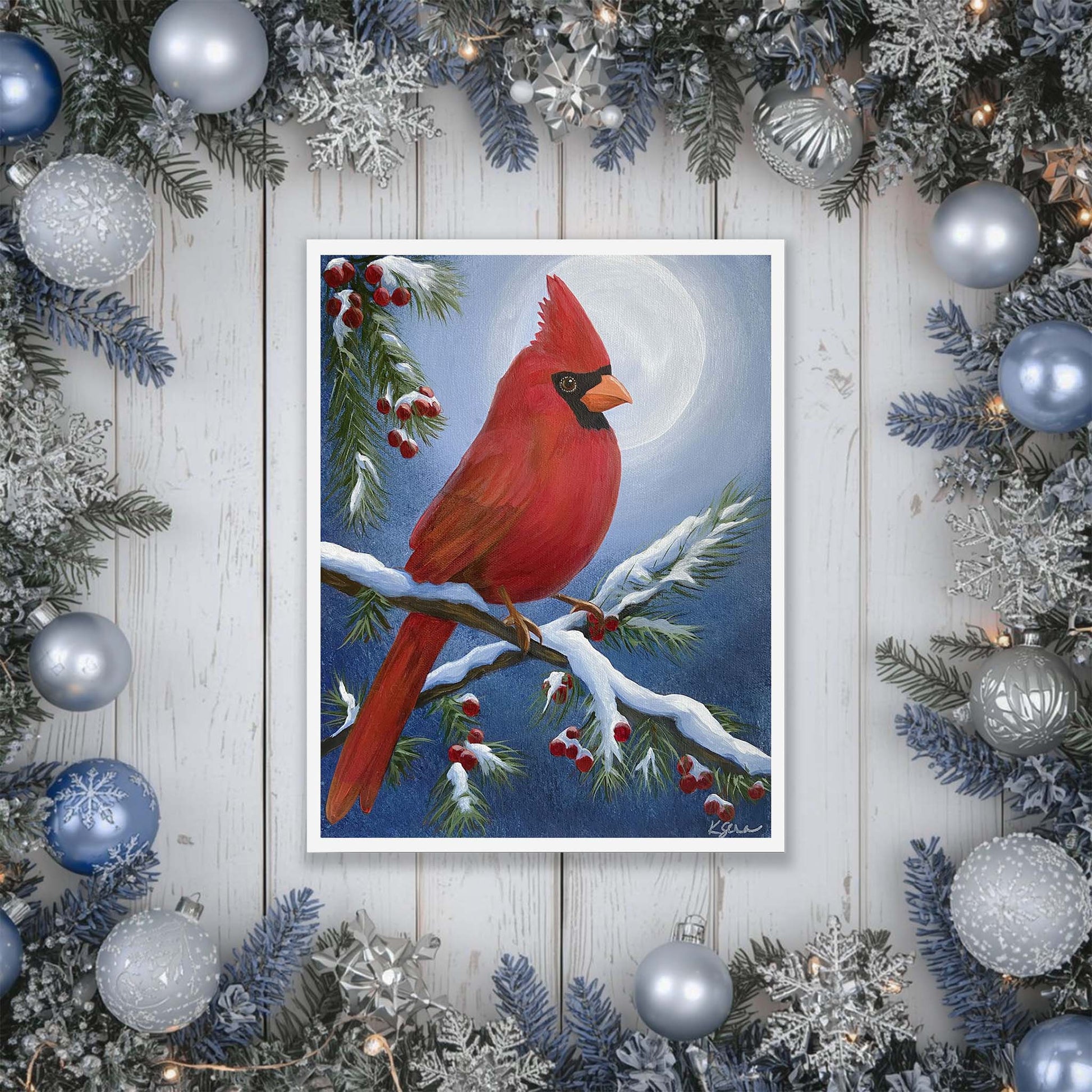 artwork of a red cardinal bird on a branch with berries, surrounded by Christmas decorations.