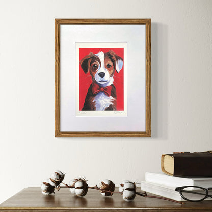 Framed artwork of a dog with a red background on a wall above a wooden surface.