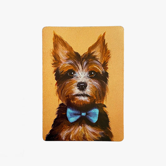 Painting of a dog with a blue bow tie on a mustard yellow background