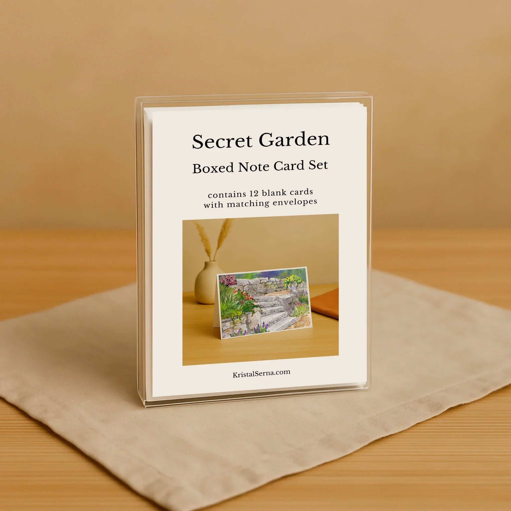 Secret Garden boxed note card set on a beige surface with a brown background