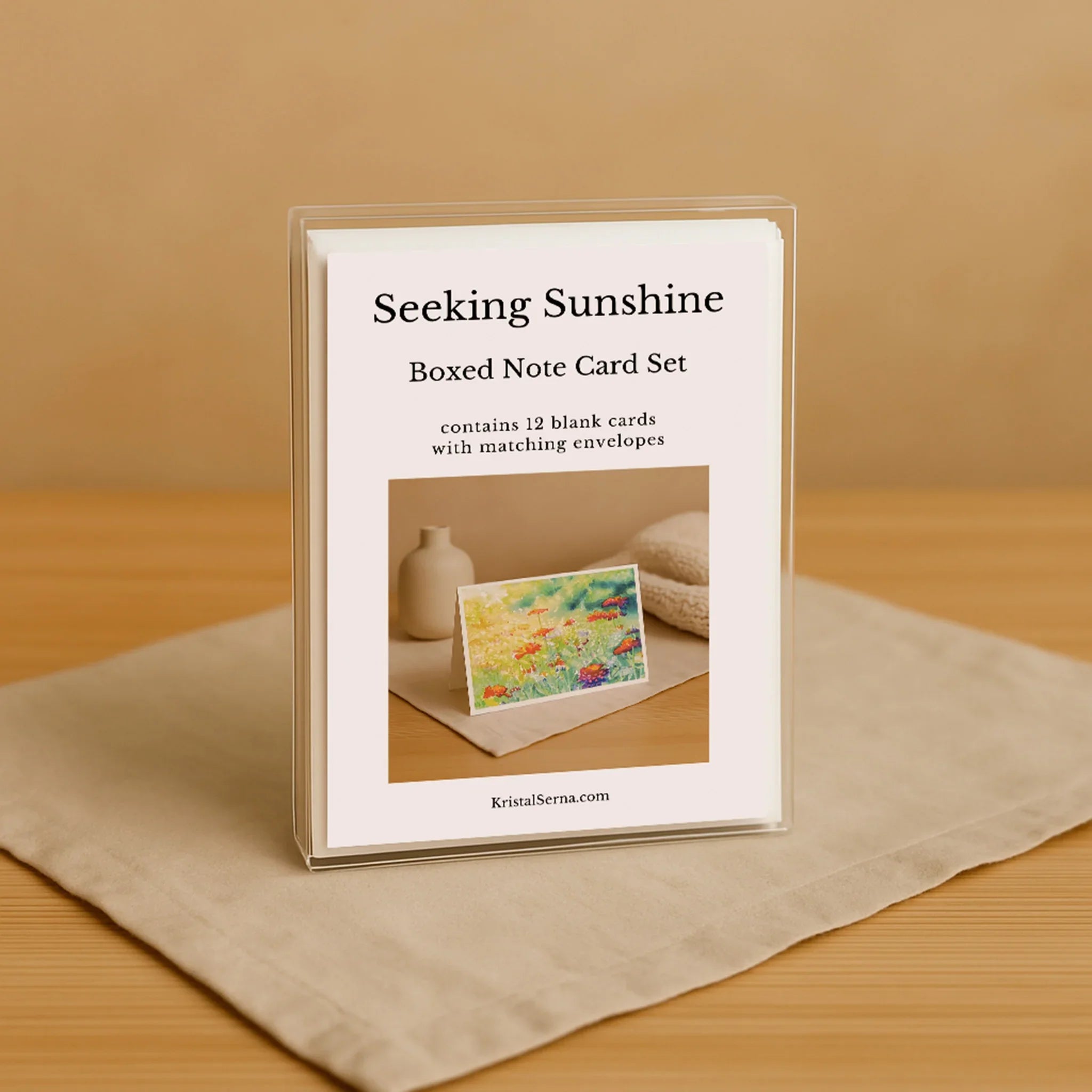 Boxed note card set titled 'Seeking Sunshine' on a beige surface with a wooden background