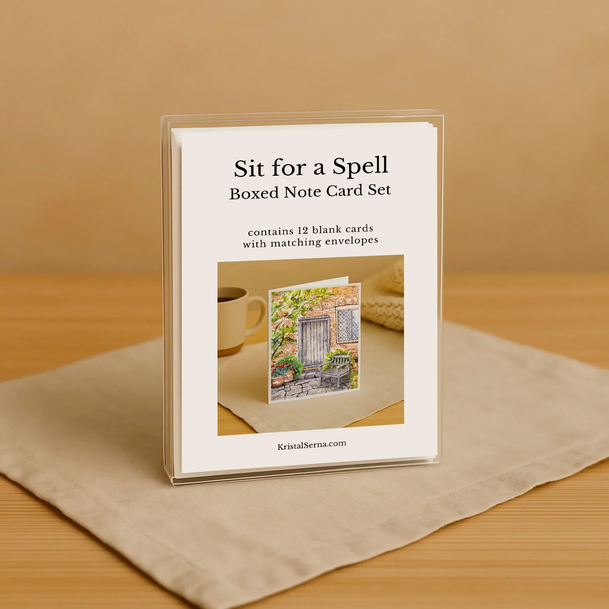 Boxed note card set with a cover featuring text and a small image of a card on a beige surface.