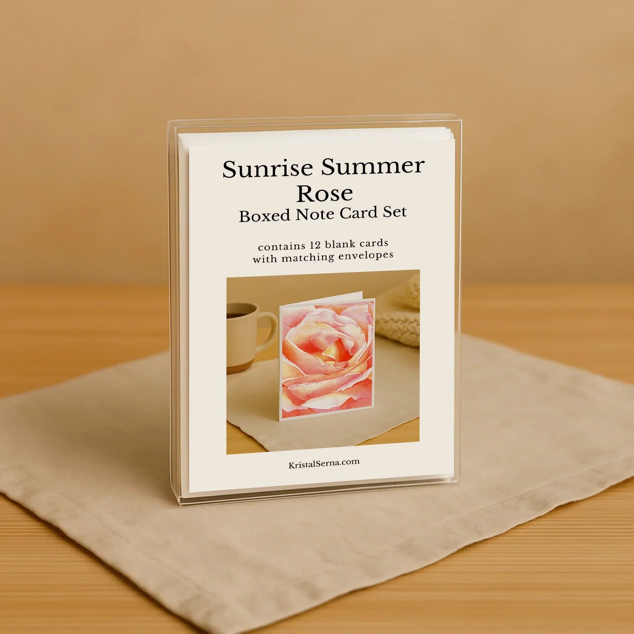 Boxed note card set titled 'Sunrise Summer Rose' on a beige surface with a brown background