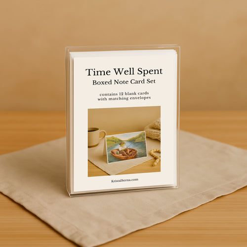 Boxed note card set titled 'Time Well Spent' on a beige surface with a wooden background