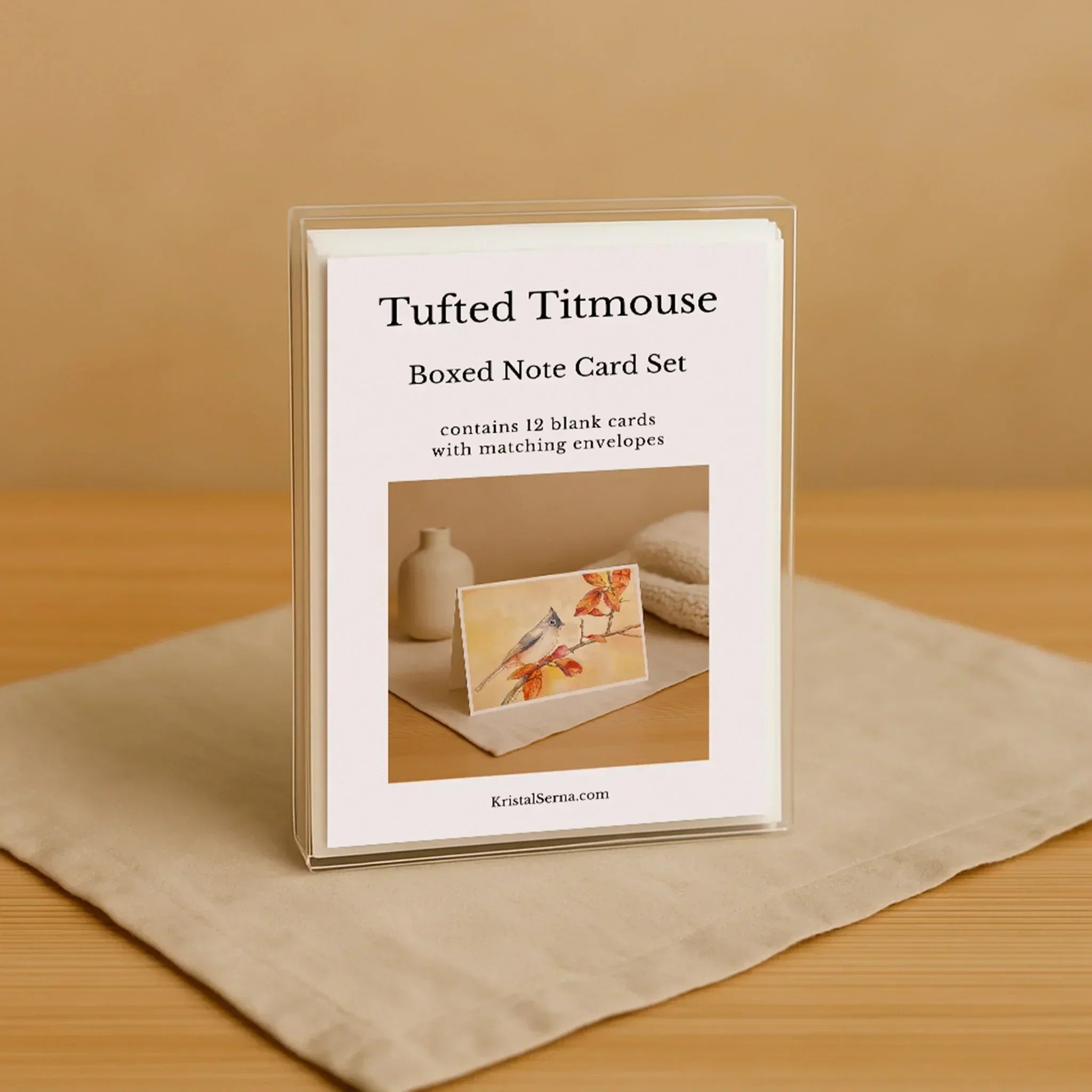 Boxed note card set with 'Tufted Titmouse' branding on a beige surface.