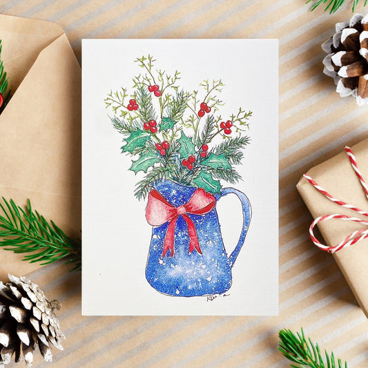 A watercolor and ink painting of a blue pitcher with a red bow, filled with holly leaves, red berries, and evergreen branches.